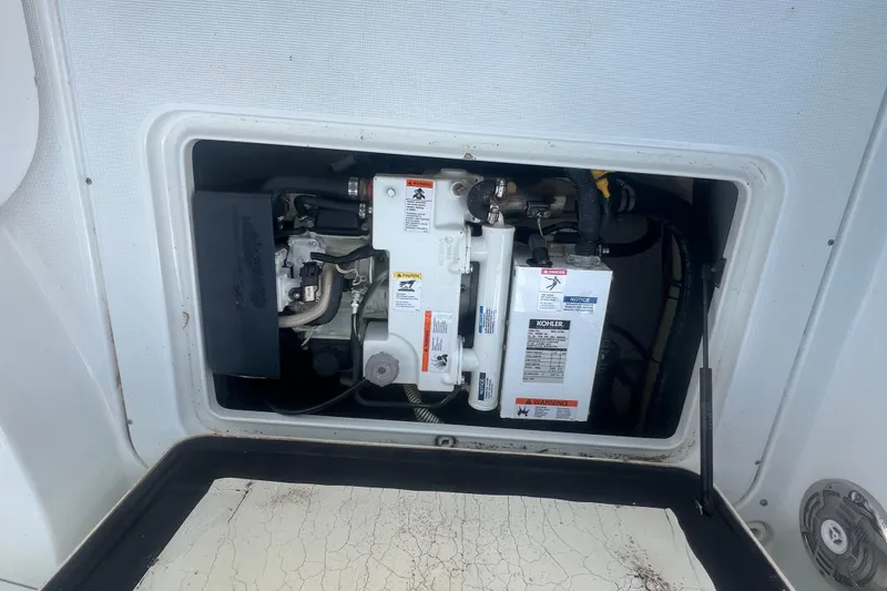 Slide: The Image of Engine compartment of a 2008 Formula 310 Sun Sport boat, featuring Kohler components. - 16