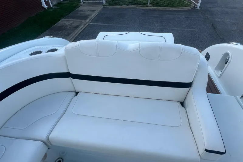 Slide: The Image of 2008 Formula 310 Sun Sport boat with white seating and cup holders. - 19