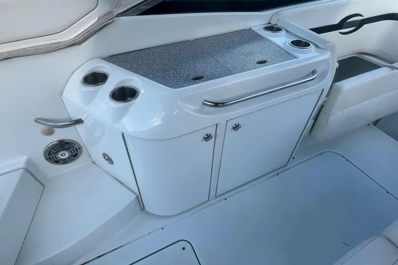 Slide: The Image of 2008 Formula 310 Sun Sport boat interior with cup holders and storage cabinet. - 21