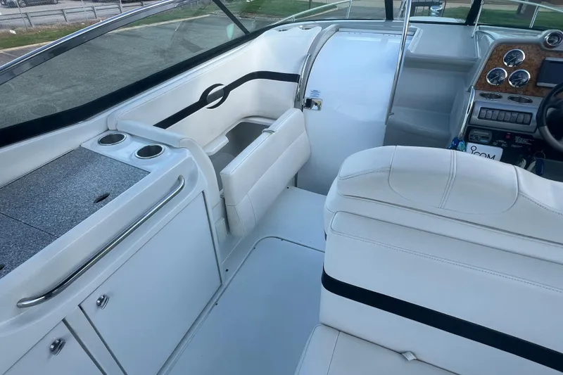 Slide: The Image of 2008 Formula 310 Sun Sport boat interior with white seating and dashboard controls. - 22