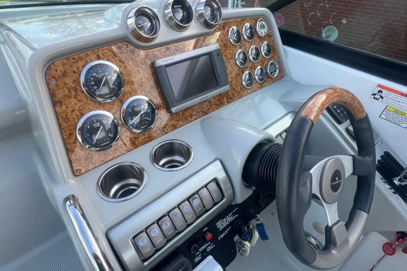 Slide: The Image of Dashboard of a 2008 Formula 310 Sun Sport boat with gauges and steering wheel. - 29