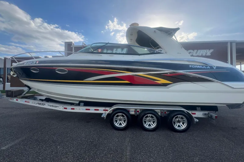 Slide: The Image of 2008 Formula 310 Sun Sport boat on trailer, sleek design with vibrant graphics. - 3