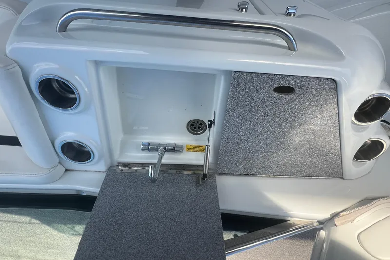 Slide: The Image of 2008 Formula 310 Sun Sport boat interior with storage compartment and cup holders. - 30