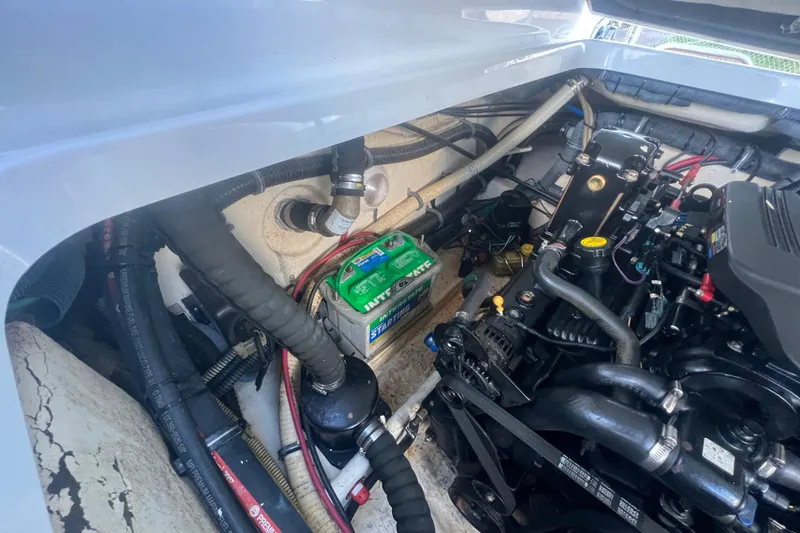 Slide: The Image of Engine compartment of a 2008 Formula 310 Sun Sport boat, showcasing battery and mechanical components. - 36