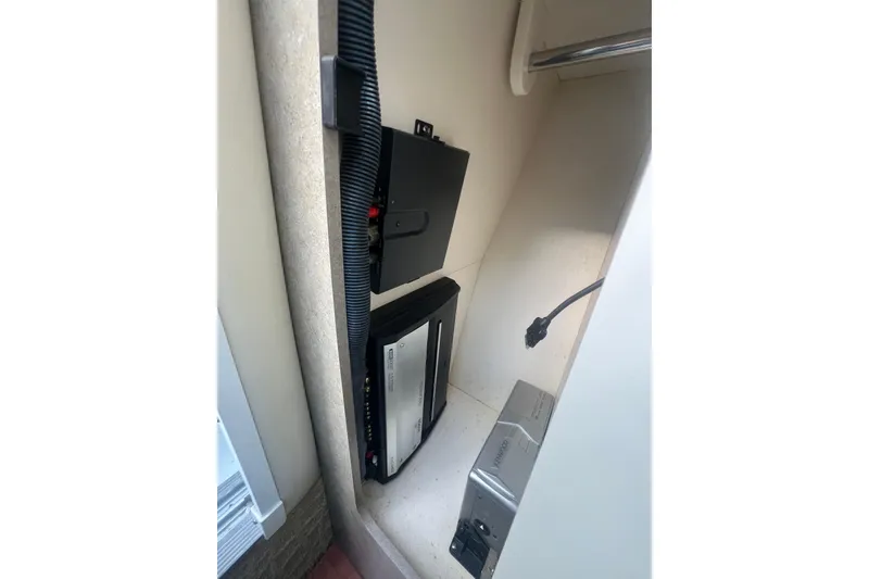 Slide: The Image of 2008 Formula 310 Sun Sport interior electronics compartment with wiring and components. - 47