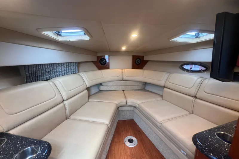 Slide: The Image of Luxurious interior of a 2008 Formula 310 Sun Sport boat with beige seating and wood flooring. - 49