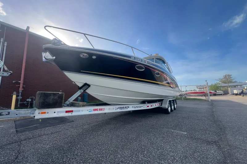 Slide: The Image of 2008 Formula 310 Sun Sport boat on trailer, parked outdoors under a clear blue sky. - 5