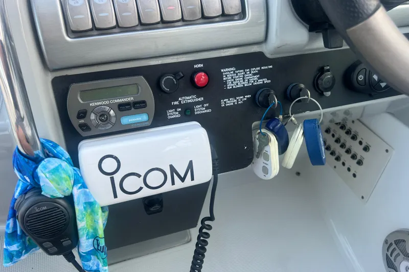 Slide: The Image of Control panel of a 2008 Formula 310 Sun Sport boat with Icom radio and keys. - 55