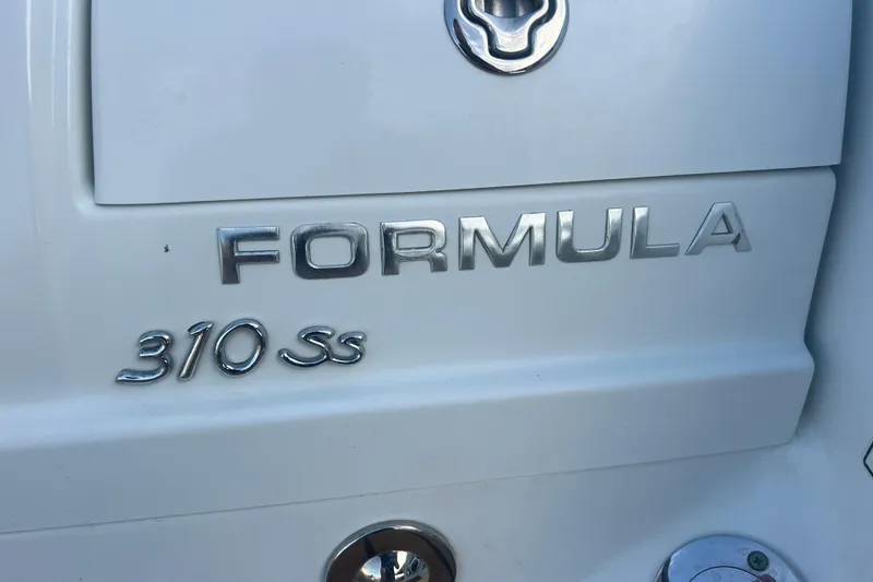 Slide: The Image of Close-up of 2008 Formula 310 Sun Sport boat emblem on white surface. - 61