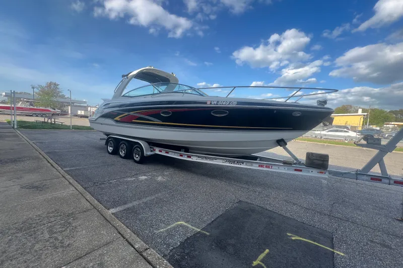 Slide: The Image of 2008 Formula 310 Sun Sport boat on trailer under a partly cloudy sky. - 7