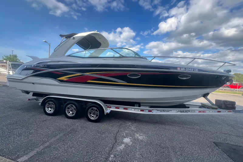Slide: The Image of 2008 Formula 310 Sun Sport boat on trailer under a partly cloudy sky. - 8