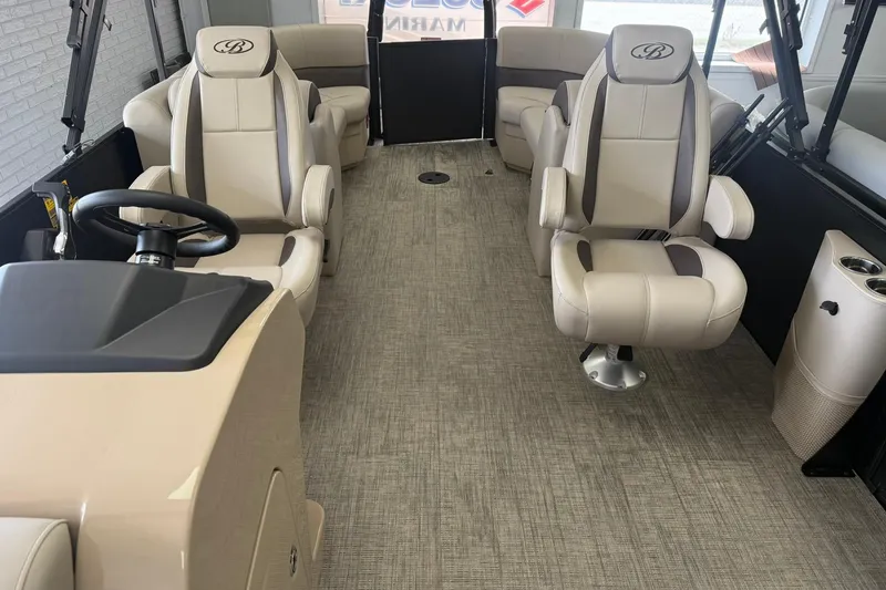 Slide: The Image of Interior of 2026 Bentley Pontoons Legacy 243 DL Navigator with luxurious seating and steering console. - 3