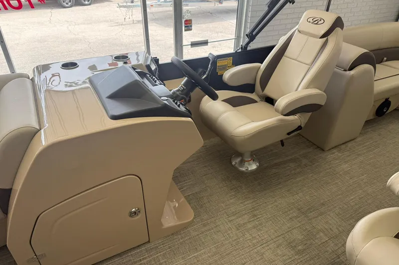 Slide: The Image of 2026 Bentley Pontoons Legacy 243 DL Navigator helm with beige captain's chair and console. - 4
