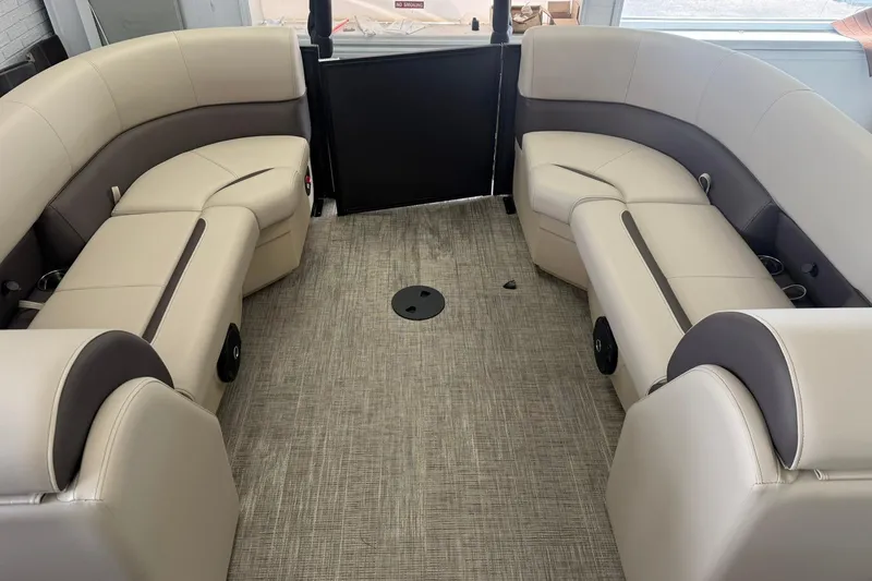 Slide: The Image of 2026 Bentley Pontoons Legacy 243 DL Navigator interior with beige seating and carpeted floor. - 5