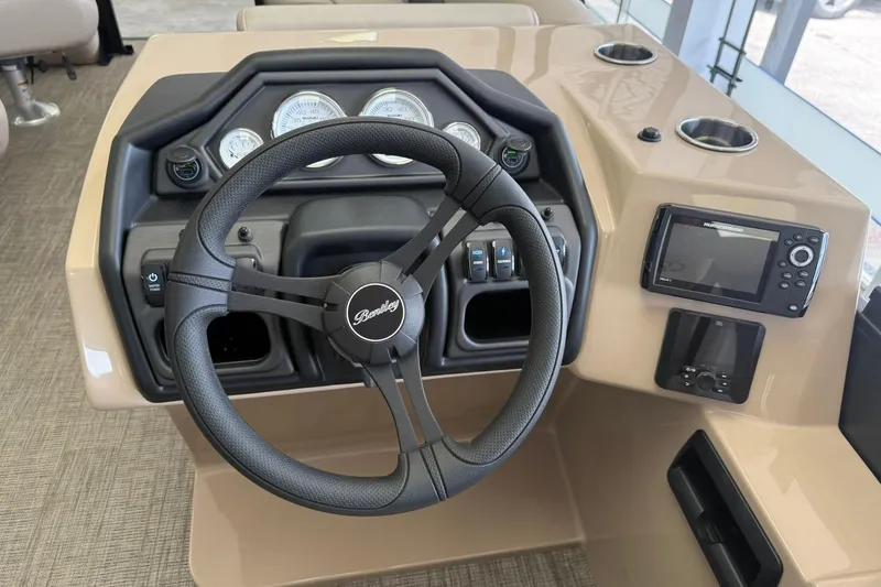 Slide: The Image of 2026 Bentley Pontoons Legacy 243 DL Navigator dashboard with steering wheel and navigation system. - 7