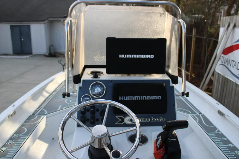 Slide: The Image of 2021 Xpress H22B Bay boat dashboard with Humminbird electronics and steering wheel. - 10
