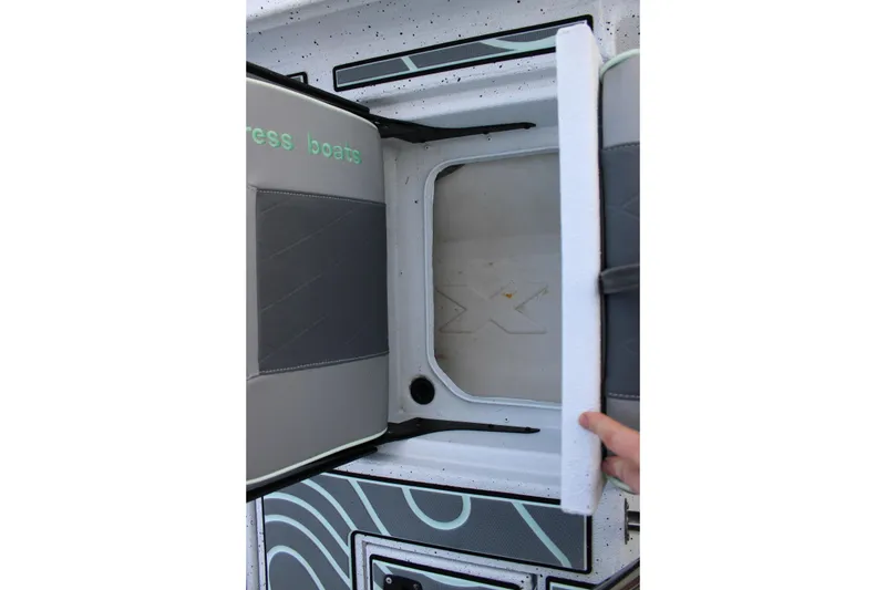 Slide: The Image of Open storage compartment on 2021 Xpress H22B Bay boat, showcasing interior design. - 13