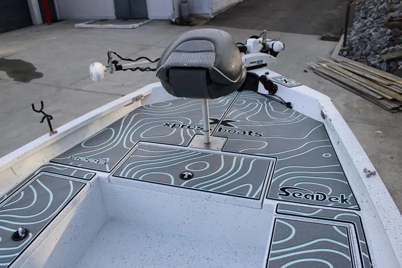 Slide: The Image of 2021 Xpress H22B Bay boat deck with SeaDek flooring and Minn Kota trolling motor. - 5