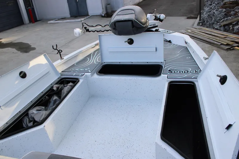Slide: The Image of 2021 Xpress H22B Bay boat interior with open storage compartments and SeaDek flooring. - 6