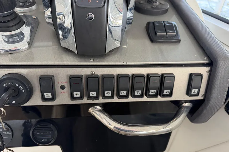 Slide: The Image of Control panel on a 2015 Cruisers Yachts 390 Express Coupe with labeled switches. - 17