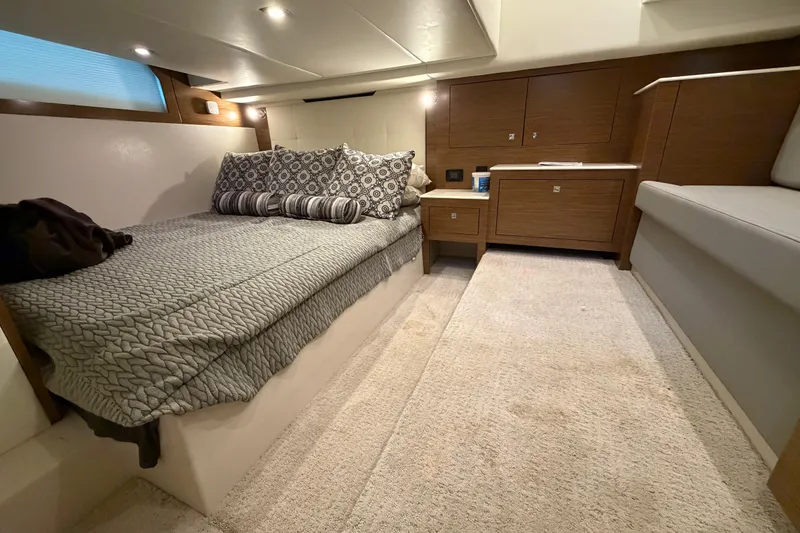 Slide: The Image of Luxurious interior cabin of 2015 Cruisers Yachts 390 Express Coupe with cozy bed and wood accents. - 24