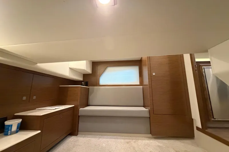 Slide: The Image of Interior of 2015 Cruisers Yachts 390 Express Coupe, featuring modern wood cabinetry and seating. - 26