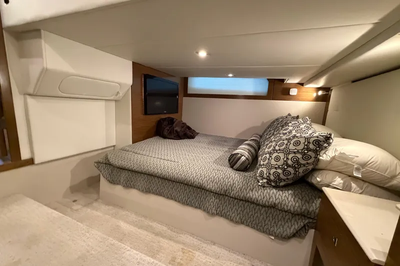 Slide: The Image of Luxurious cabin interior of 2015 Cruisers Yachts 390 Express Coupe with cozy bedding. - 31