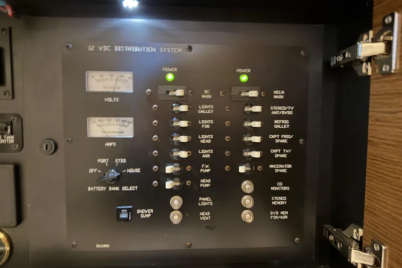 Slide: The Image of 12V DC distribution panel on 2015 Cruisers Yachts 390 Express Coupe, showing power controls and indicators. - 34