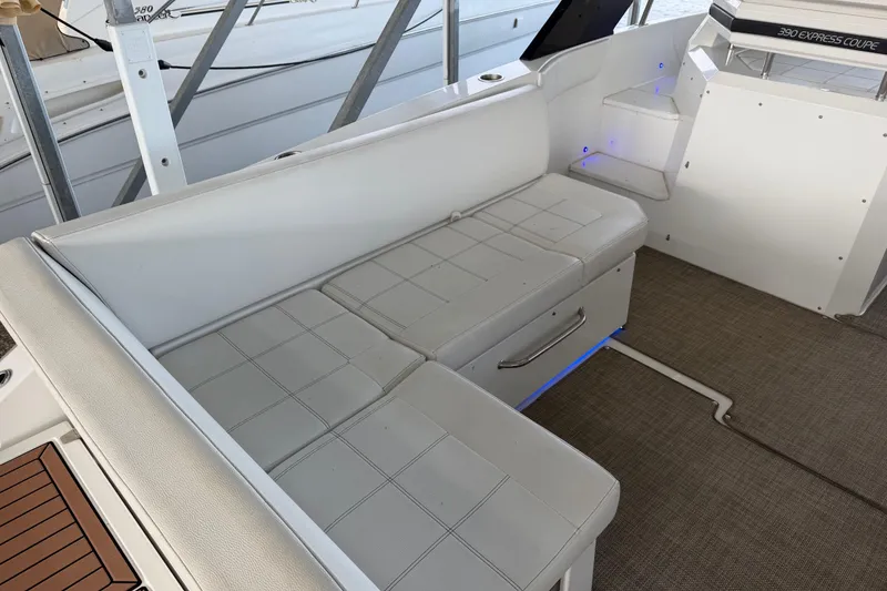 Slide: The Image of 2015 Cruisers Yachts 390 Express Coupe interior with white seating and modern design. - 4
