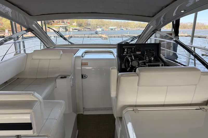 Slide: The Image of Interior view of 2015 Cruisers Yachts 390 Express Coupe, featuring sleek helm and seating. - 6