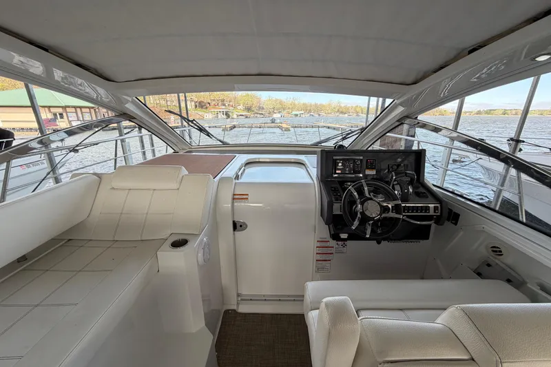 Slide: The Image of 2015 Cruisers Yachts 390 Express Coupe helm with modern controls and waterfront view. - 7