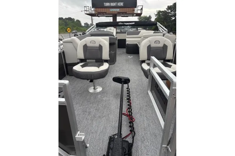 Slide: The Image of 2026 Sun Tracker Fishin' Barge 22 DLX interior with seating and fishing equipment. - 10