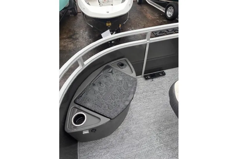 Slide: The Image of 2026 Sun Tracker Fishin' Barge 22 DLX interior with wet deck and cup holder. - 13