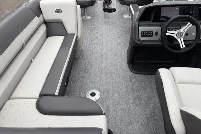 Slide: The Image of 2026 Sun Tracker Fishin' Barge 22 DLX interior with gray and white seating. - 21