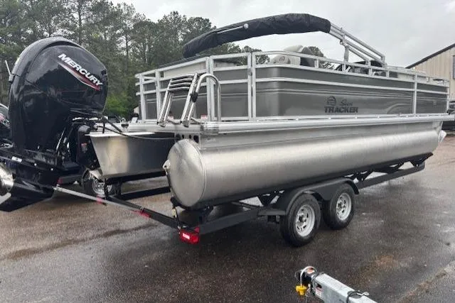 Slide: The Image of 2026 Sun Tracker Fishin' Barge 22 DLX pontoon boat on trailer with Mercury outboard motor. - 5