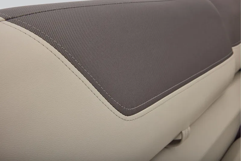 Slide: The Image of Manufacturer Provided Image: 2026 Sun Tracker Fishin' Barge 22 DLX seat detail, featuring beige and gray upholstery. - 57