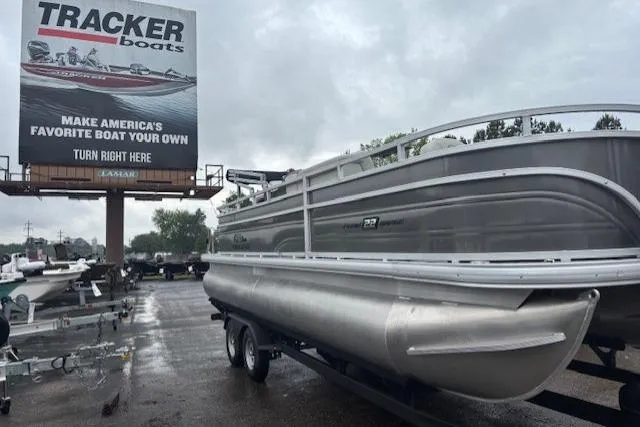 Slide: The Image of 2026 Sun Tracker Fishin' Barge 22 DLX pontoon boat on trailer, overcast day. - 6
