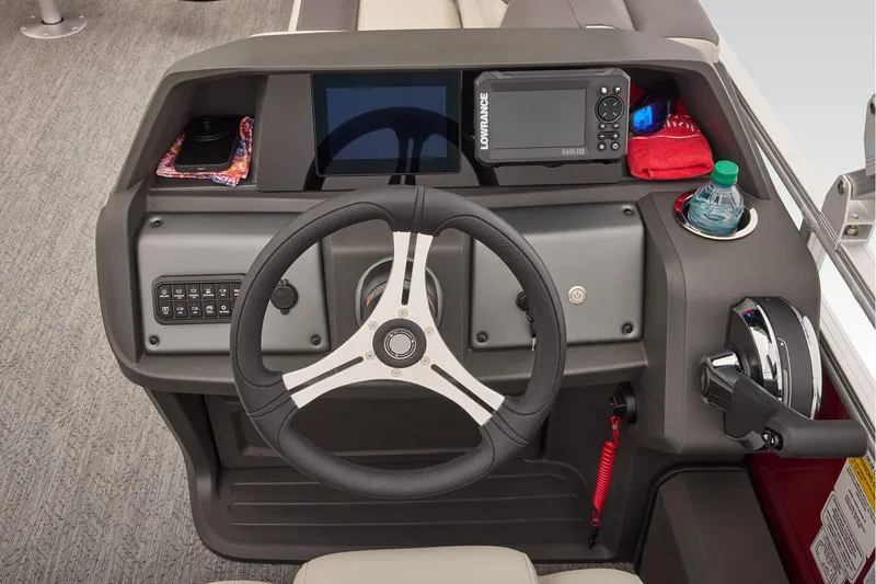 Slide: The Image of Manufacturer Provided Image: 2026 Sun Tracker Fishin' Barge 22 DLX helm with steering wheel and control panel. - 62