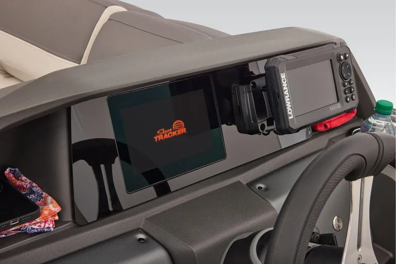 Slide: The Image of Manufacturer Provided Image: 2026 Sun Tracker Fishin' Barge 22 DLX dashboard with Lowrance electronics and steering wheel. - 63