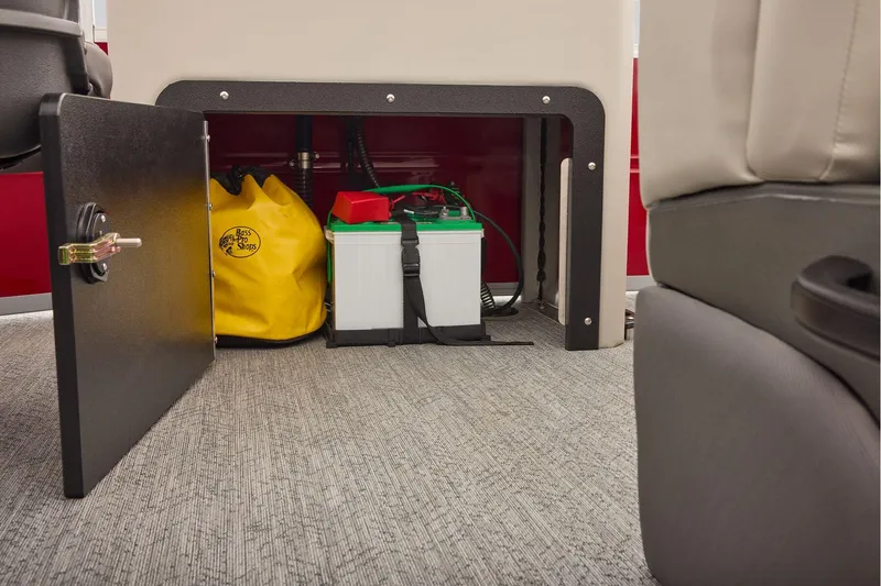 Slide: The Image of Manufacturer Provided Image: Storage compartment in 2026 Sun Tracker Fishin' Barge 22 DLX with battery and gear bag. - 76
