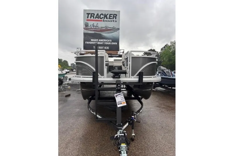 Slide: The Image of 2026 Sun Tracker Fishin' Barge 22 DLX pontoon boat on trailer, overcast day. - 8