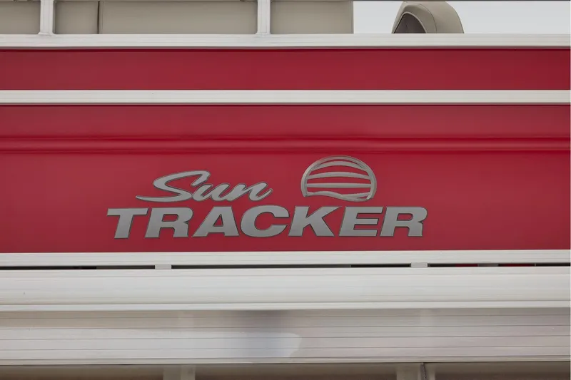 Slide: The Image of Manufacturer Provided Image: 2026 Sun Tracker Fishin' Barge 22 DLX logo on red background. - 89