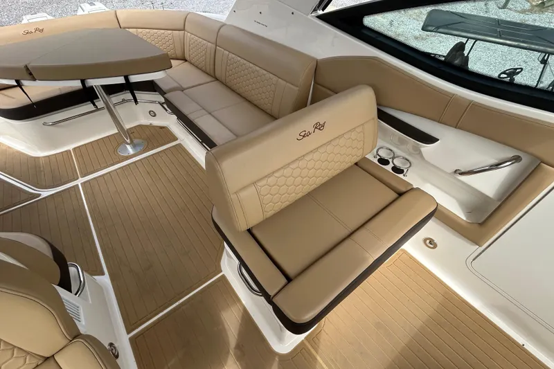 Slide: The Image of Luxurious interior of 2022 Sea Ray Sundancer 320 Outboard with tan seating and table. - 13