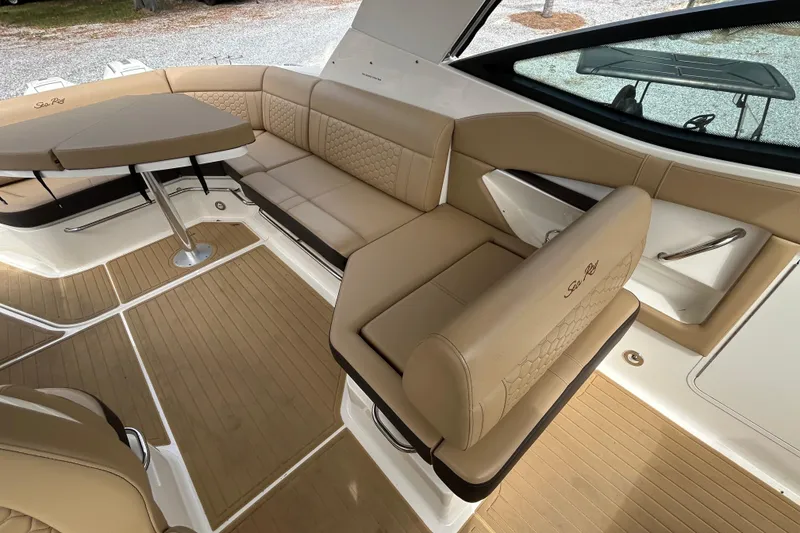 Slide: The Image of Luxurious interior of 2022 Sea Ray Sundancer 320 Outboard with beige seating and table. - 14