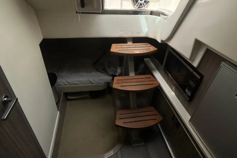 Slide: The Image of Interior cabin of 2022 Sea Ray Sundancer 320 Outboard with wooden steps and modern amenities. - 21