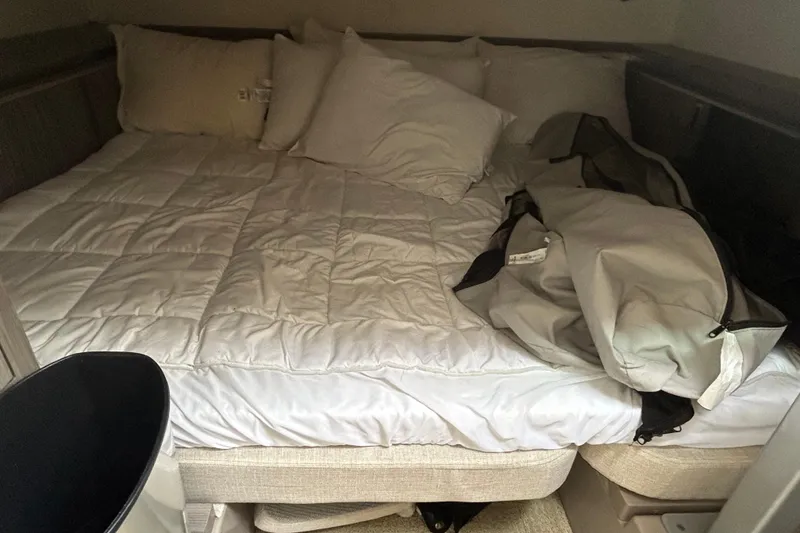 Slide: The Image of Cozy cabin bed in 2022 Sea Ray Sundancer 320 Outboard with white bedding and pillows. - 22