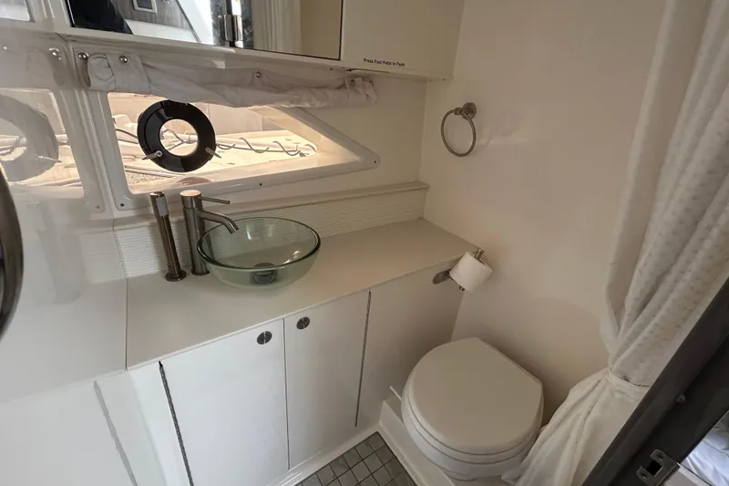 Slide: The Image of 2022 Sea Ray Sundancer 320 Outboard bathroom with modern sink and toilet. - 26