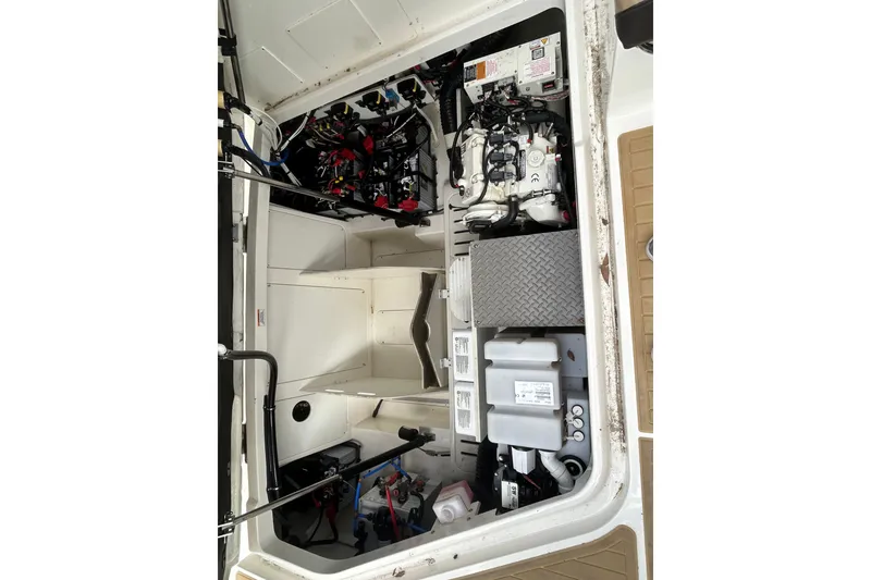 Slide: The Image of Engine compartment of 2022 Sea Ray Sundancer 320 Outboard, showcasing mechanical components and wiring. - 27