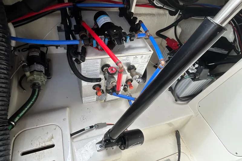 Slide: The Image of Engine compartment of a 2022 Sea Ray Sundancer 320 Outboard with visible wiring and components. - 28