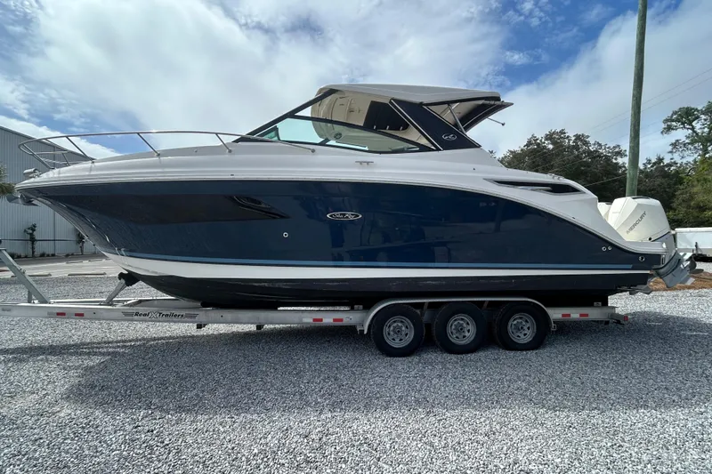 Slide: The Image of 2022 Sea Ray Sundancer 320 Outboard on trailer, side view, blue and white design. - 6